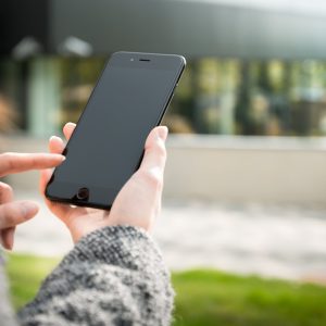 person holding mobile phone representing a telephone consultation